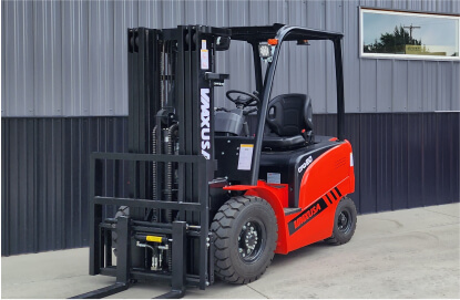A red and black forklift parked in front of a building.