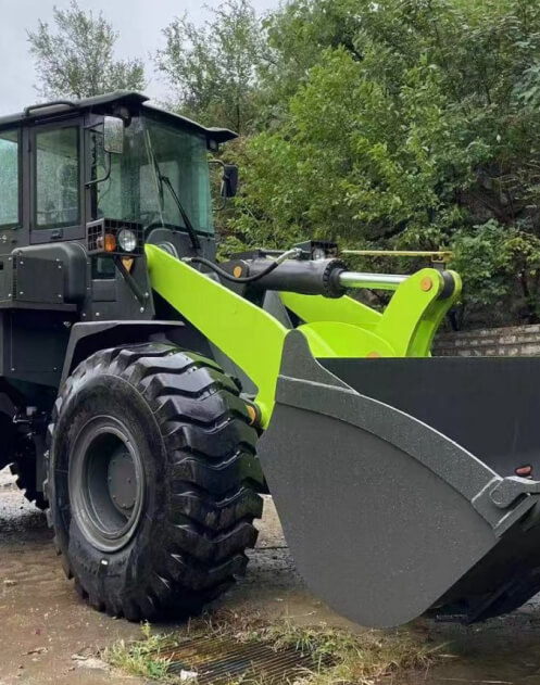 A large green and black tractor with a yellow plow.