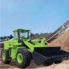 A green wheel loader is parked in the dirt.