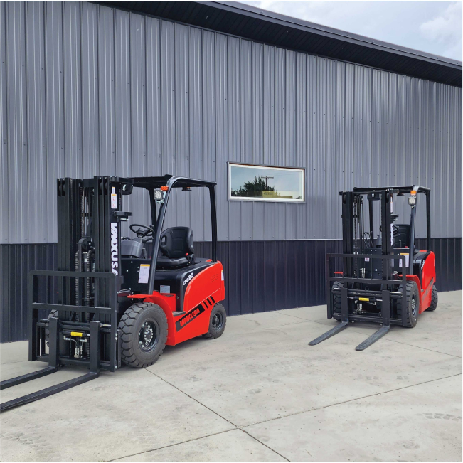 Two forklifts parked in front of a building.