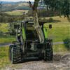 A tree trunk being cut by a tractor.