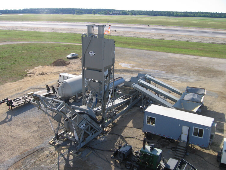 A large concrete structure on the side of an airport runway.