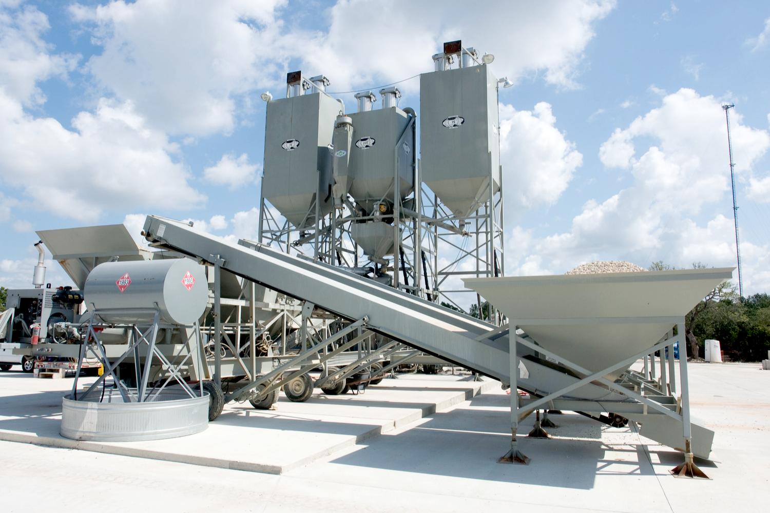 A cement plant with many large concrete mixers.